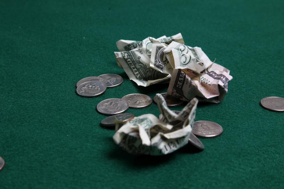Free Image of Wad of dollars and coins 