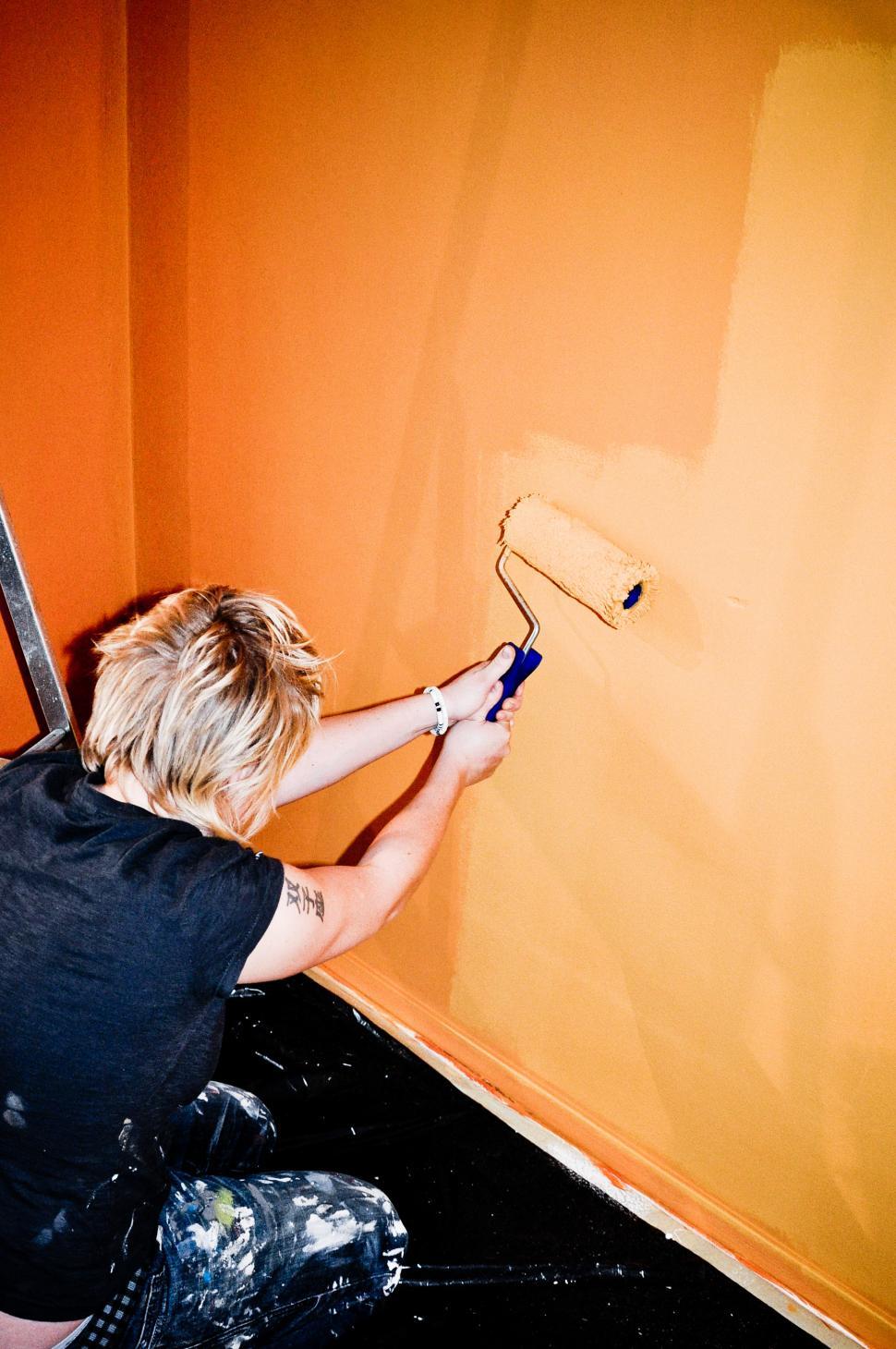 Free Image of Girl painting wall 