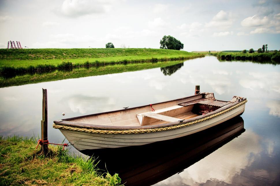 Free Image of Small Boat Floating on Body of Water 