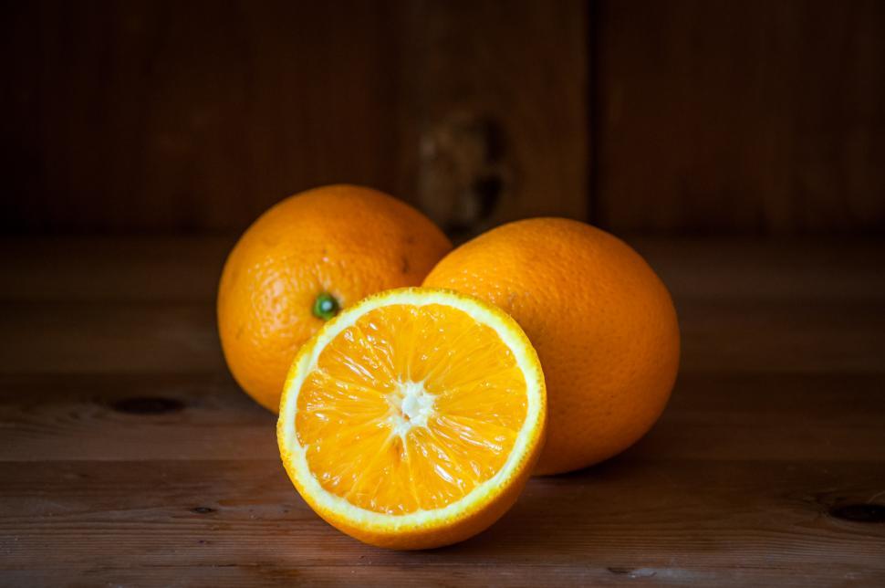 Free Image of Group of Three Fresh Orange on Wood Table 