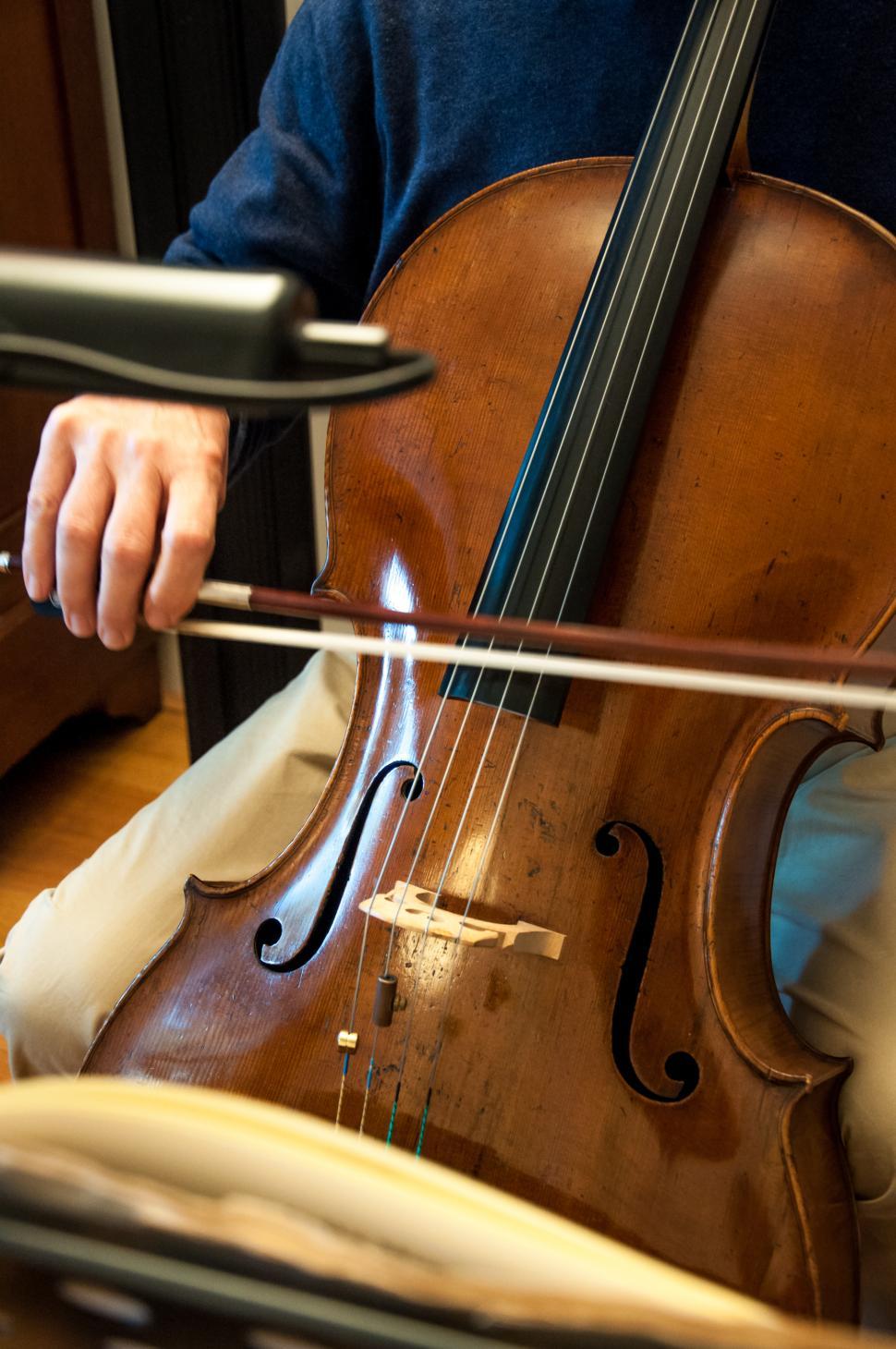 Download Free Stock Photo of Cello professional player with symphony orchestra 