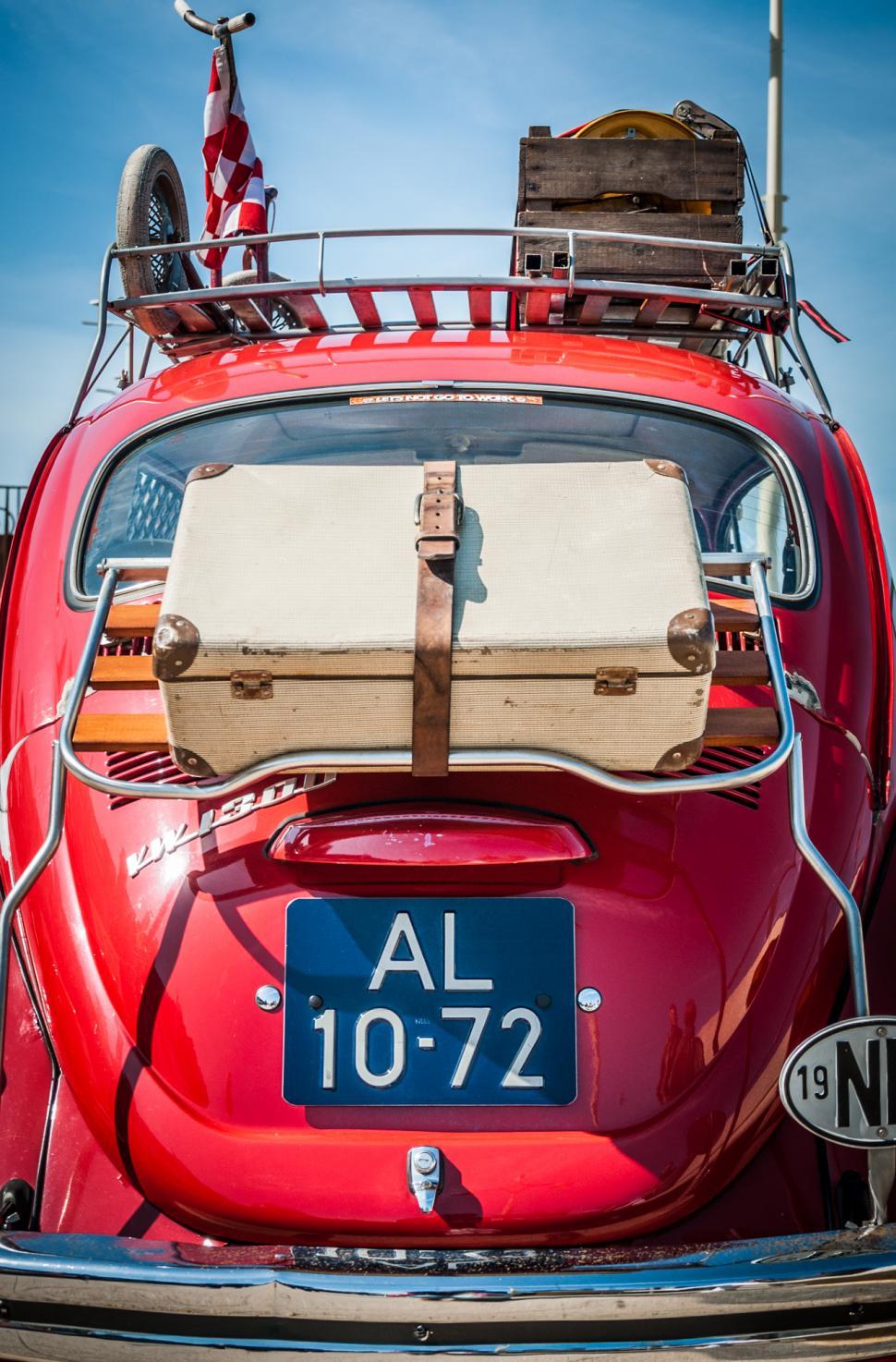 Free Image of Red Car With Luggage on Top 