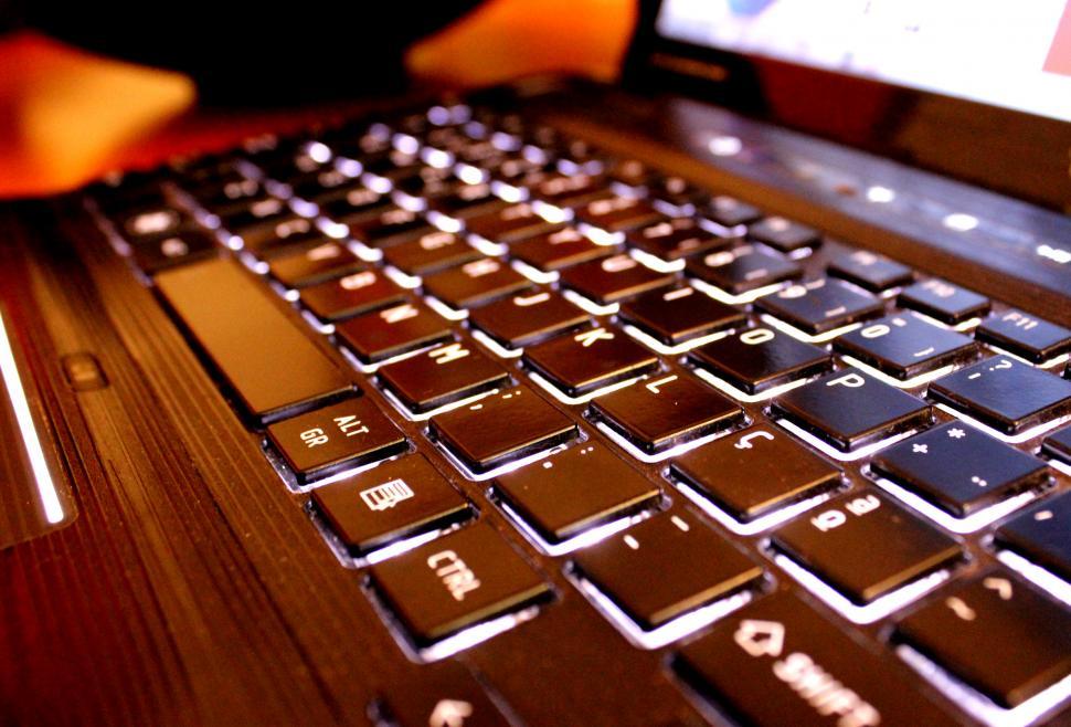 Download Free Stock Photo of Close up detail view of a laptop computer keyboard with light sh 
