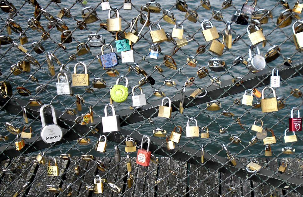 Download Free Stock Photo of Love locks placed by tourists on the Pont des Arts on the river  