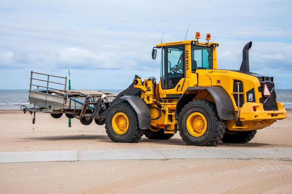 Free Image of Yellow Tractor Parked on Beach 