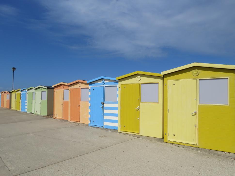 Free Image of Row of Beach Huts Basking in Sunlight 