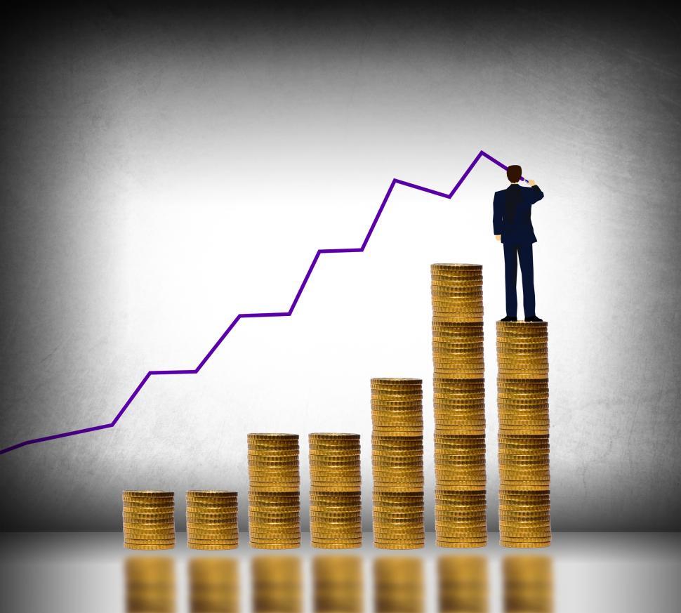 Free Image of Businessman drawing a finance graph on top of gold coin stack -  