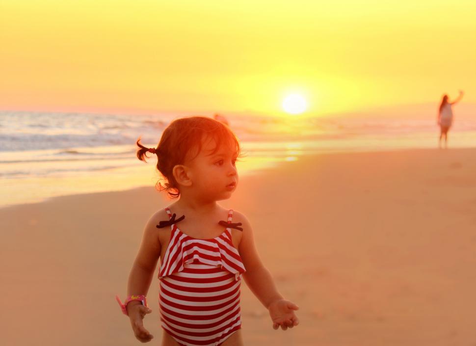 Free Image of Little girl on the beach at sunset - Summer vacations 