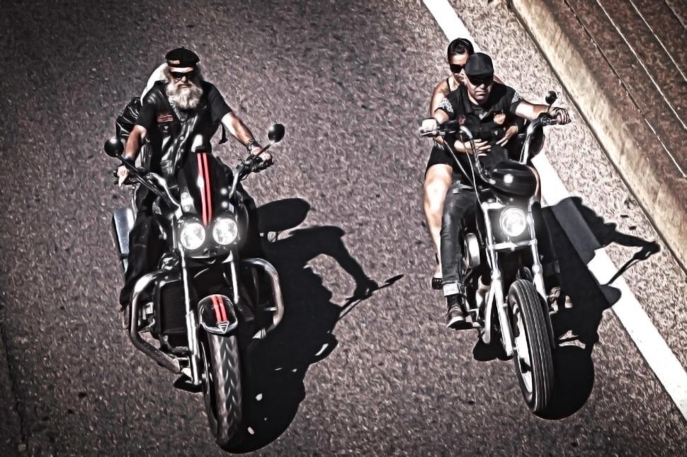 Free Image of Two generations of bikers riding choppers 