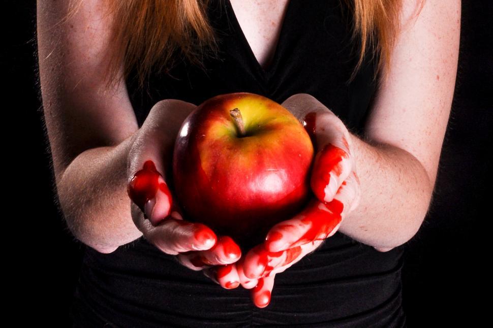 Free Image of Bloody hands holding apple 