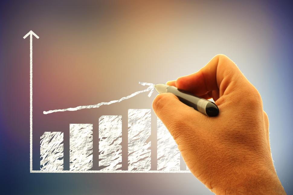 Free Image of Businessman drawing a financial graph histogram 