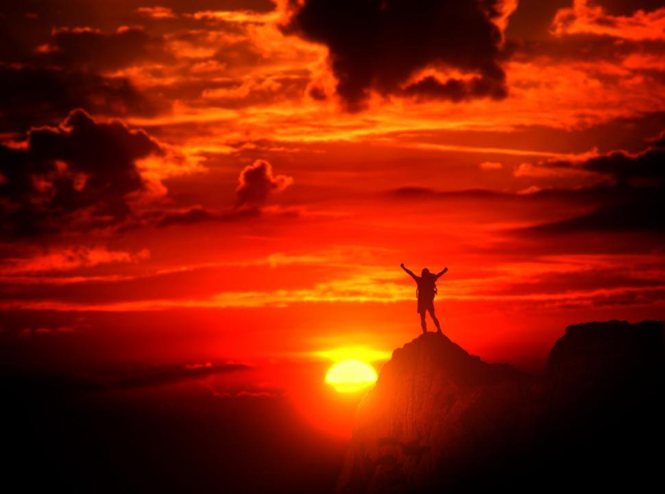 Download Free Stock Photo of Man on top of the mountain with raised arms  