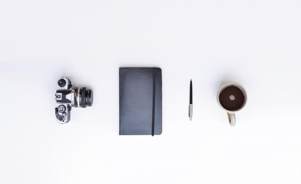 Free Image of Camera notebook and cup  