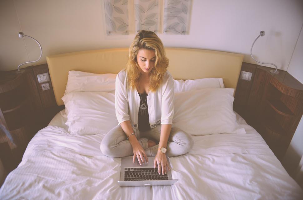 Free Image of Woman on bed working on laptop 