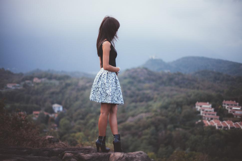 Free Image of  Woman stands on cliff  