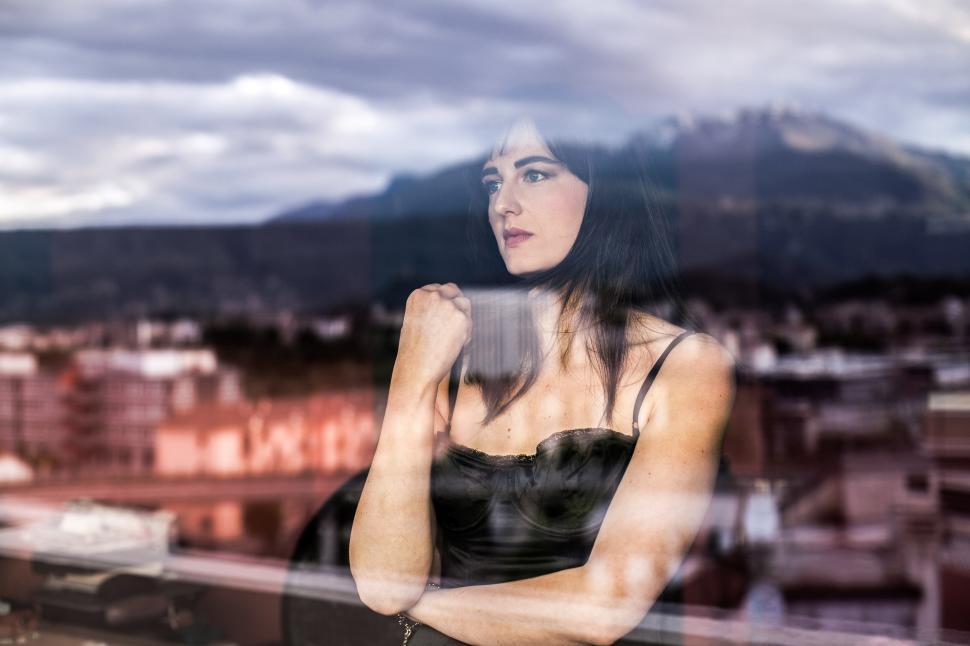 Free Image of A young Caucasian woman at window 