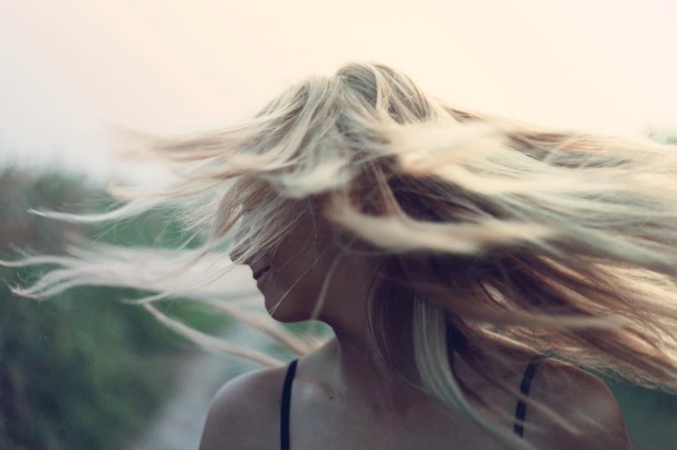 Free Image of A young Caucasian woman moving her hair  