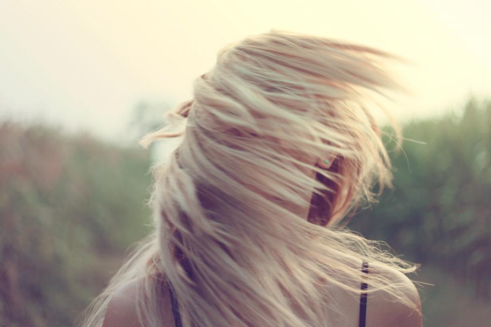 Free Image of A young Caucasian woman moving her hair 