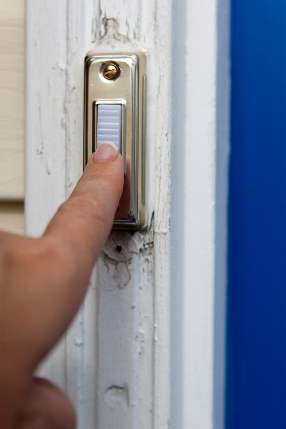 Free Image of Lady ringing a doorbell 