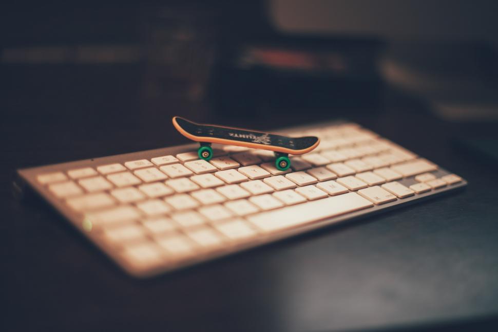 Free Image of Miniature skateboard on keyboard 