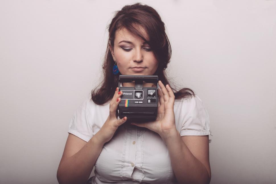 Free Image of Woman Holds Camera in Front of Face 