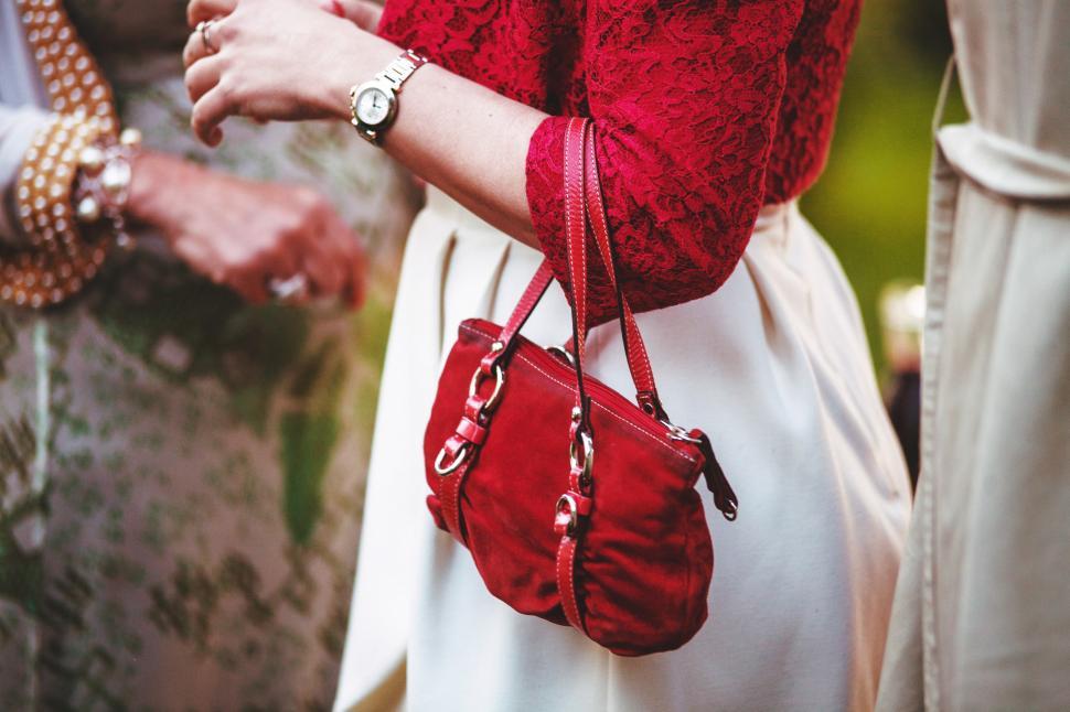 Free Image of Person Holding Red Purse Closely 