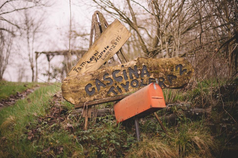 Free Image of Wooden Sign on Lush Green Hillside 