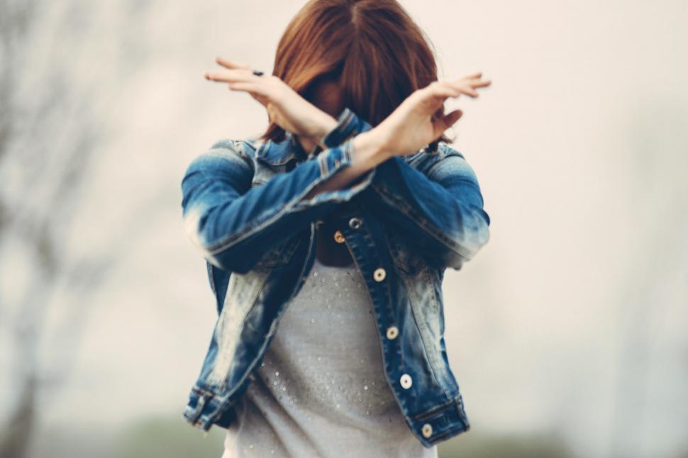Free Image of Woman Covering Her Face With Her Hands 