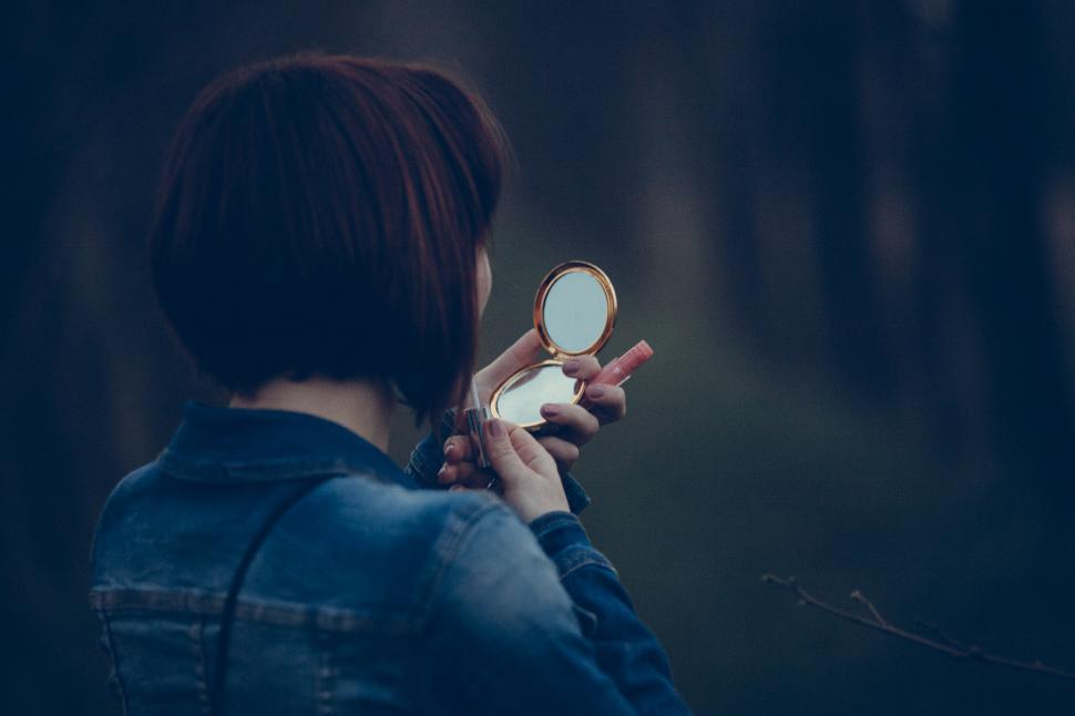 Free Image of Woman Holding Magnifying Glass in Front of Face 