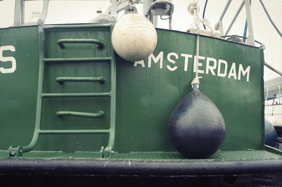 Free Image of Large Green Boat With Life Preserver on Top 