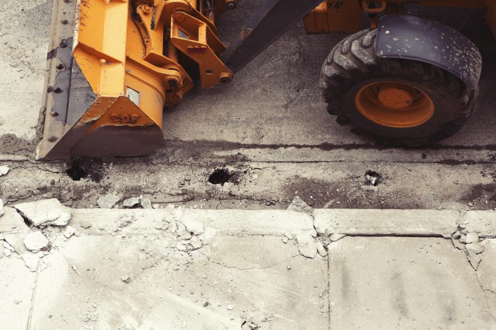 Free Image of Construction Vehicle Parked Next to Cement Wall 