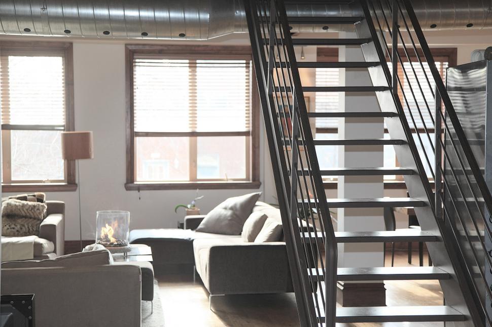 Free Image of A Living Room Filled With Furniture and a Staircase 