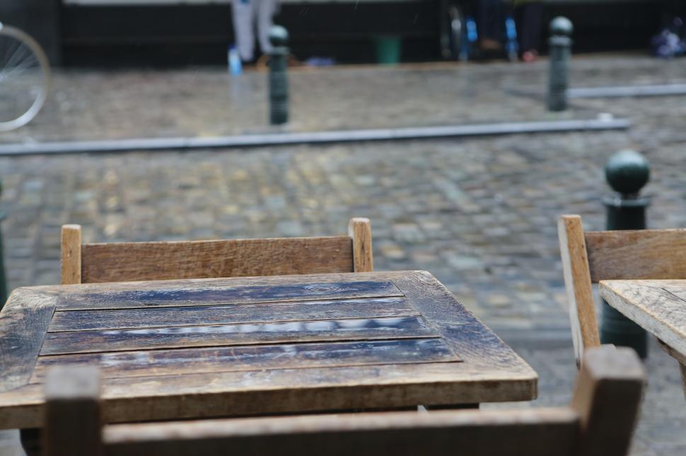 Free Image of Wooden Table and Chairs on Brick Sidewalk 