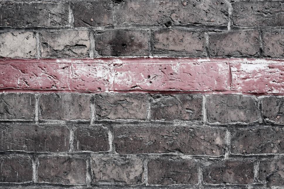 Free Image of Brick Wall With Red Line Painted 