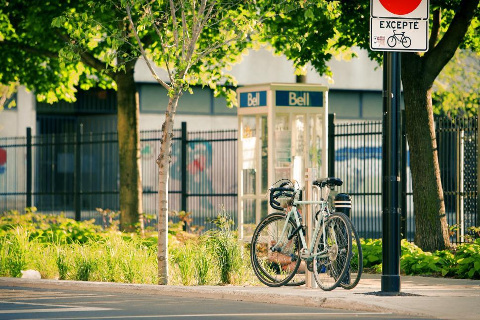 Free Image of Two Bikes Parked Next to Street Sign 