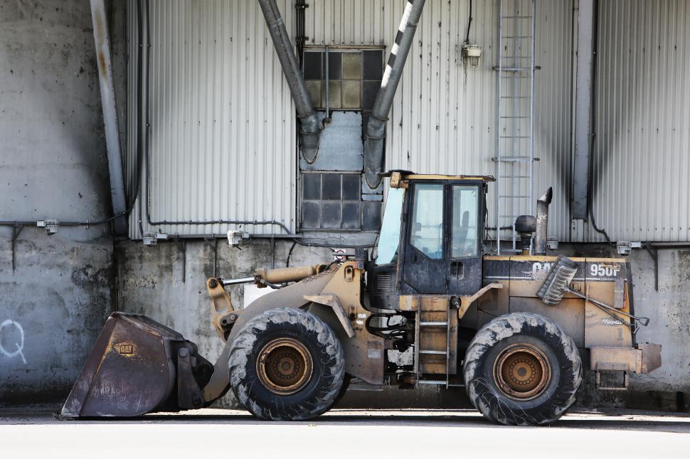 Free Image of Bulldozer Parked in Front of Building 
