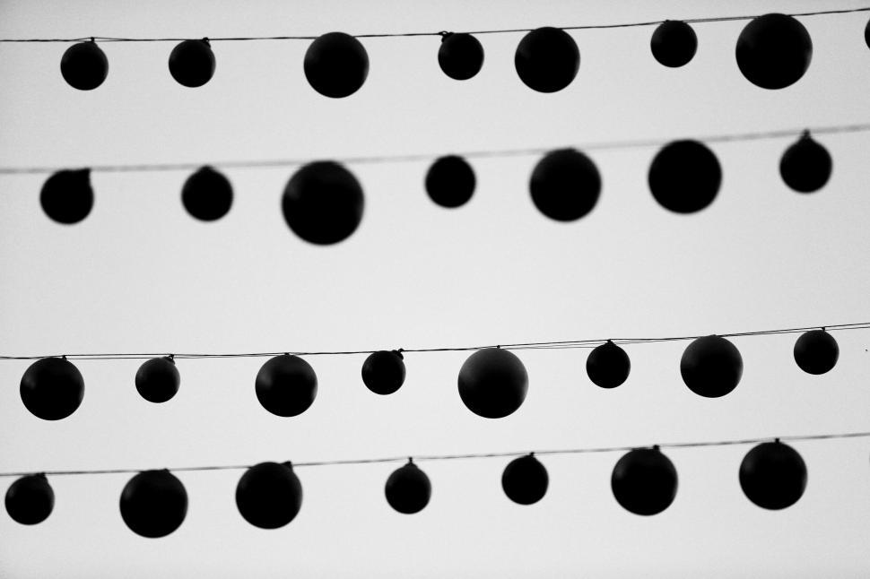 Free Image of String of Balls Hanging in Black and White 