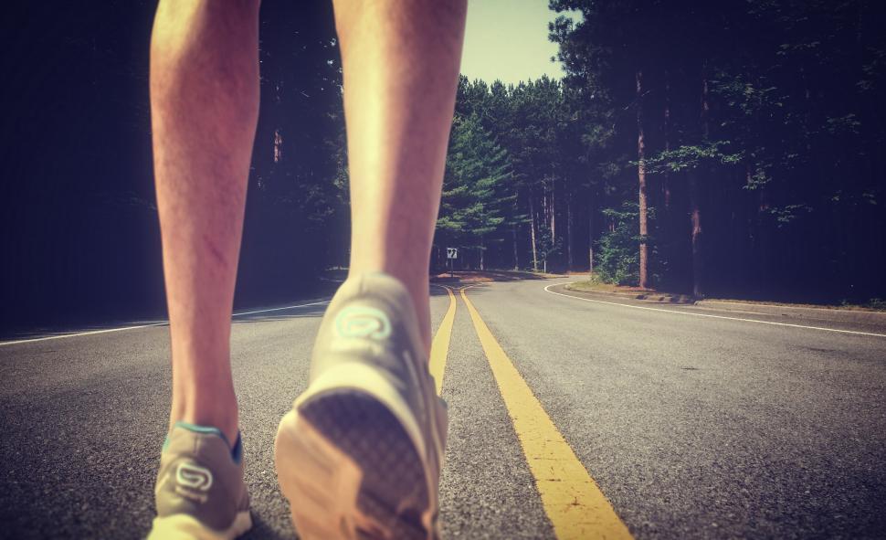 Download Free Stock Photo of Feet of an athlete running on a deserted road - Training for fit 