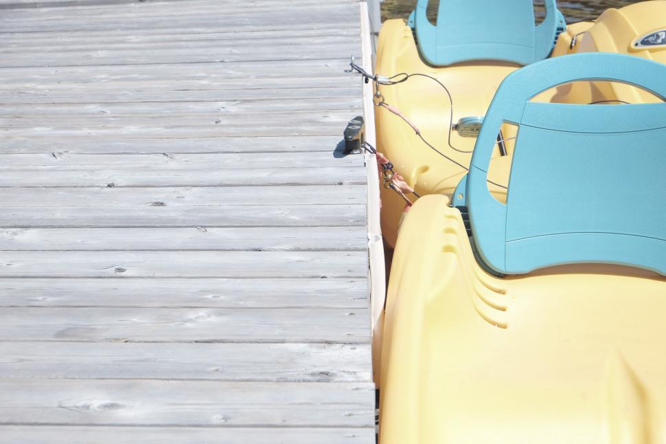 Free Image of Row of Yellow and Blue Seats on Pier 