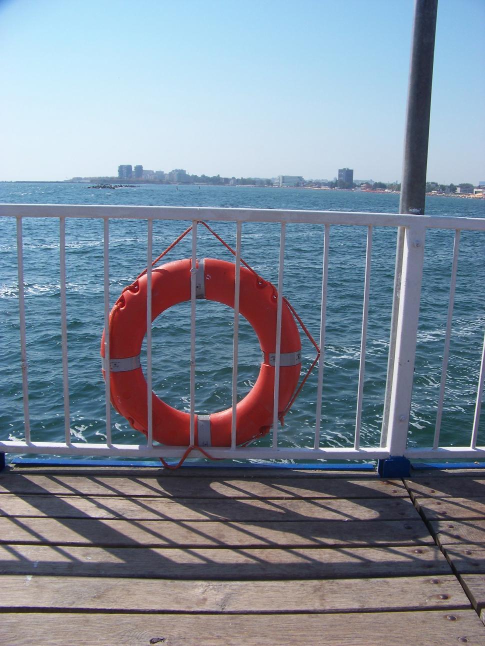 Free Image of Life buoy on the railing on the wharf in Mamaia  