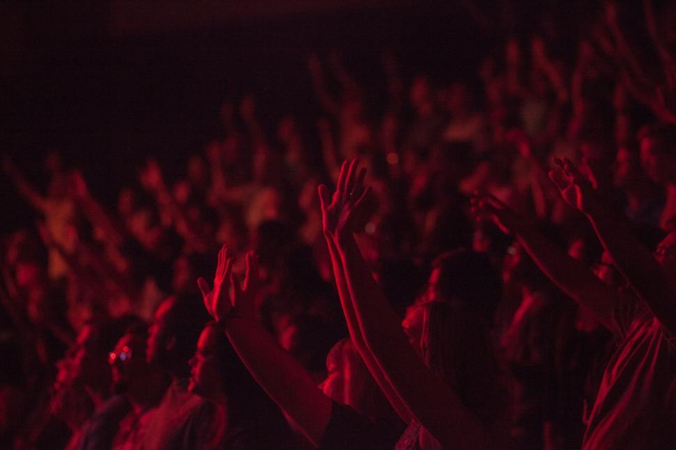 Free Image of Energetic Crowd With Hands Raised at Concert 
