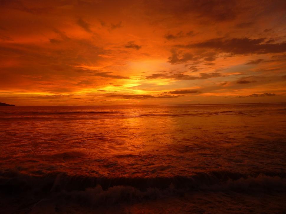 Free Image of sun sunset star sky atmosphere sunrise celestial body silhouette dusk orange water sea clouds dawn landscape evening horizon ocean beach cloud morning light scene 