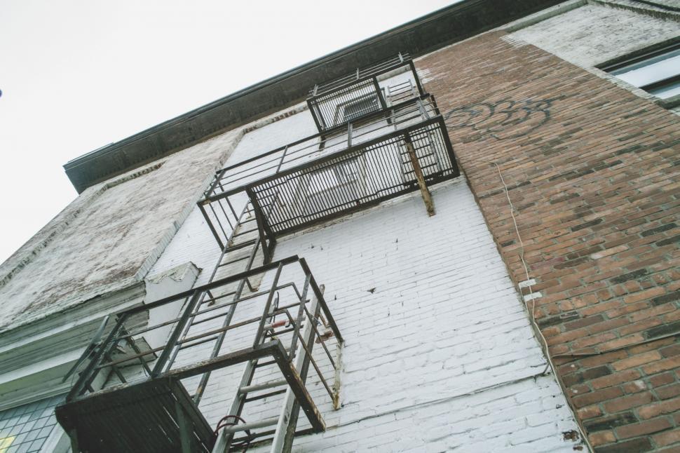 Free Image of Tall Brick Building With Fire Escape 