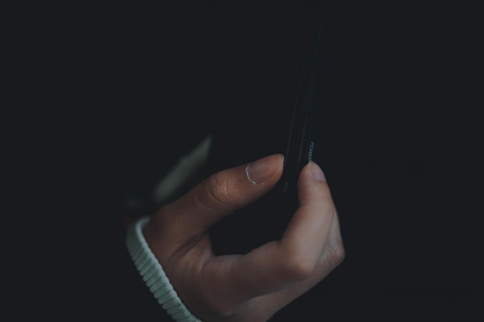 Free Image of Hand Holding Cell Phone in the Dark 