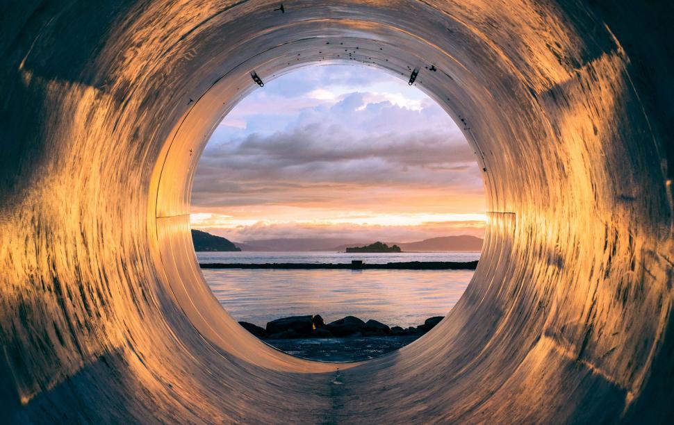 Free Image of A View of a Body of Water From Inside a Pipe 