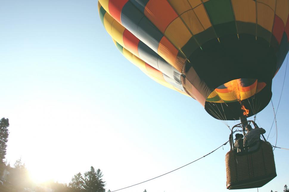 Free Image of Large Hot Air Balloon Flying Through Blue Sky 