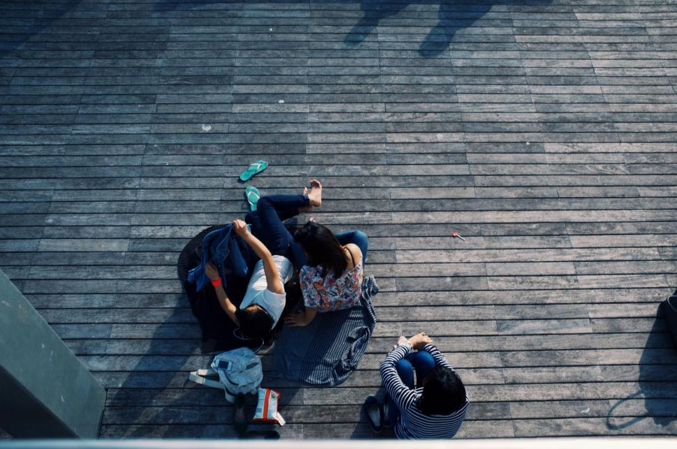 Free Image of Group of People Standing on Top of a Roof 