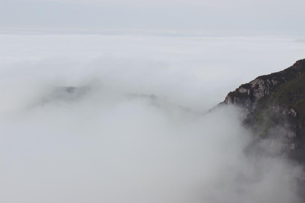 Free Image of Foggy Mountain With Bird Flying Over 