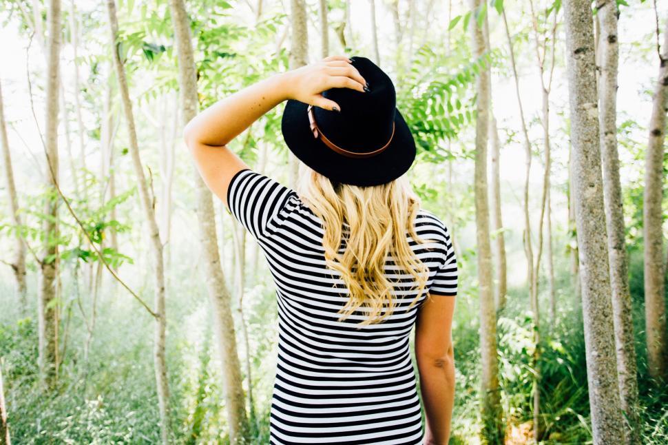 Free Image of Woman Standing in Forest With Hat 