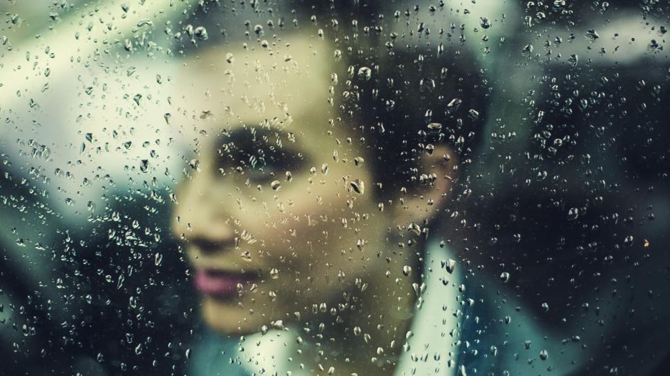 Free Image of Man Looking Out of Car Window in Rain 